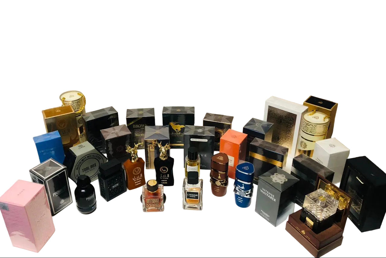 Collection of various perfume bottles and containers on a white surface with a beige background
